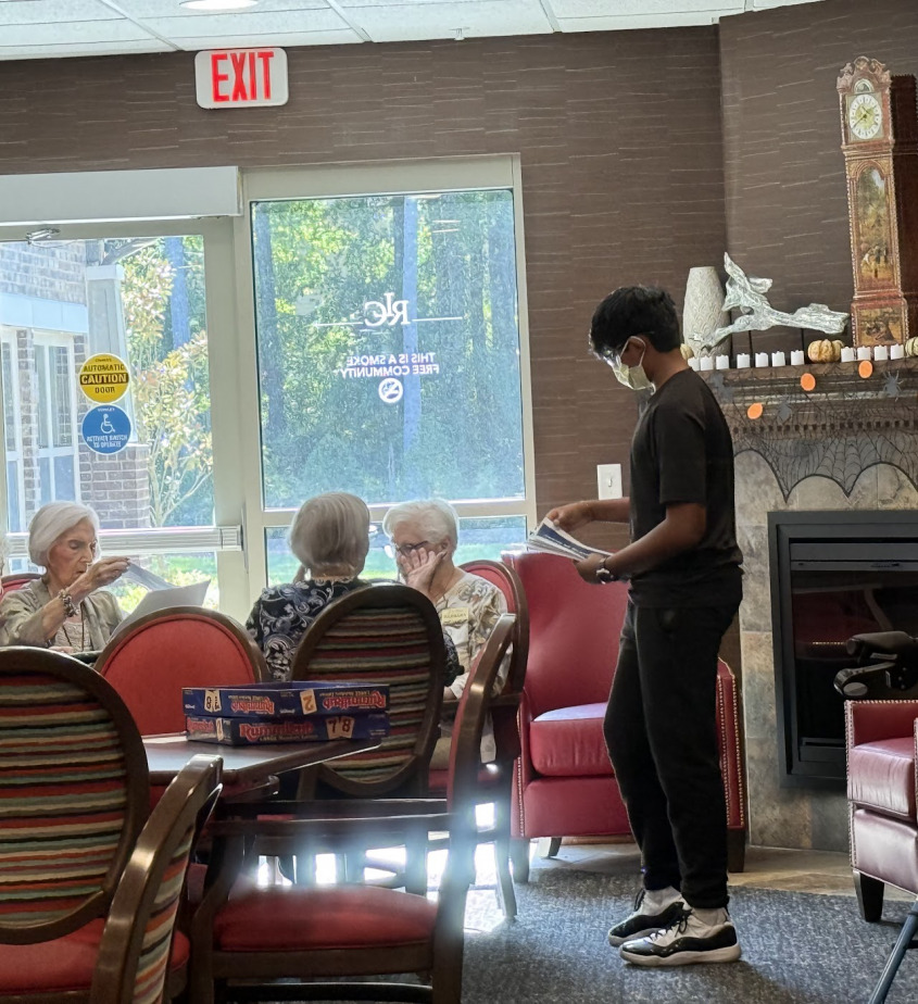 A student speaking with a group of seniors